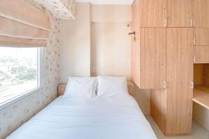 Cozy Living 2BR Green Pramuka City Apartment near Mall By Travelio