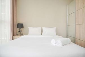 Homey and Warm 1BR at Ciputra International Apartment By Travelio