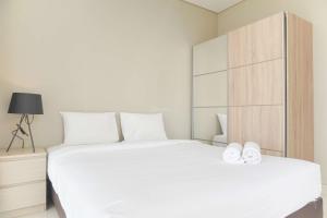 Homey and Warm 1BR at Ciputra International Apartment By Travelio