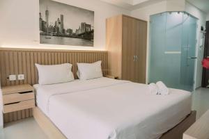 Good and Homey Studio at Pacific Garden Alam Sutera Apartment By Travelio