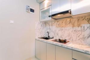 Homey and Minimalist 1BR Royal Sentul Park Apartment By Travelio