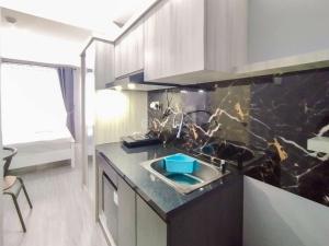 Homey Grey Studio Apartment at Grand Asia Afrika Bandung By Travelio
