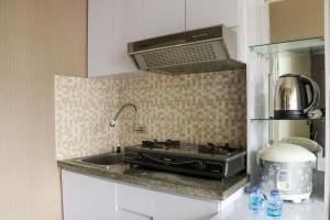 Homey and Cozy Stay 2BR at Green Pramuka City Apartment By Travelio