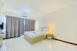 Homey Studio (No Kitchen) at Grand Palace Kemayoran Apartment By Travelio