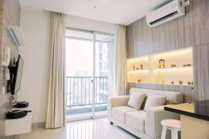 Spacious and Warm 2BR at Ciputra World 2 Apartment By Travelio