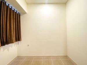 Spacious and Homey 2BR with Extra Room at Meikarta Apartment By Travelio