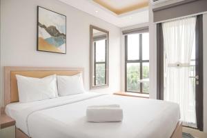 Warm and Minimalist Studio Transpark Bintaro Apartment By Travelio