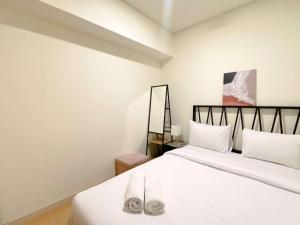 Clean and Homey 2BR at Meikarta Apartment By Travelio