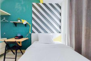 Minimalist Studio at Tree Park City BSD Apartment By Travelio