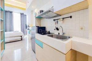 Minimalist Studio at Tree Park City BSD Apartment By Travelio