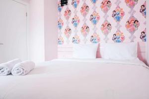 Homey and Fresh 2BR Green Pramuka Apartment By Travelio