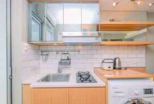 Big and Cozy 1BR Bassura City Apartment near Mall By Travelio