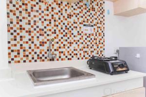 Simple and Cozy Living Studio Room at Bassura City Apartment By Travelio