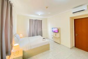 Good and Cozy Studio (Free IPL & Utilities) Grand Palace Kemayoran Apartment By Travelio