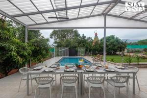 Grey Hues with Swimming Pool & Lawn at Karjat by StayVista