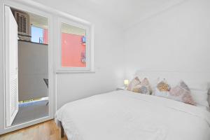 Charming White Apartment with Balcony and Parking