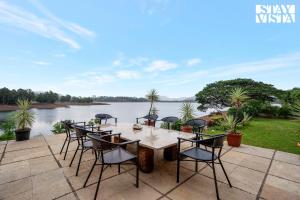 StayVista at Three Shores with Lake View & Alfresco Dining