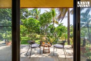 StayVista at Three Shores with Lake View & Alfresco Dining