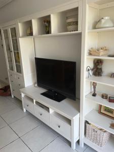 Bajo con jardín en primera línea de playa