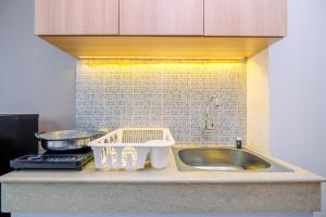 Minimalist Studio Room at Evenciio Margonda Apartment By Travelio