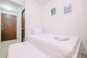 Minimalist and Cozy Studio (No Kitchen) Transpark Cibubur Apartment By Travelio