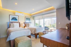 Upscale Corner Unit with Large Wrap Around Balcony and Pools