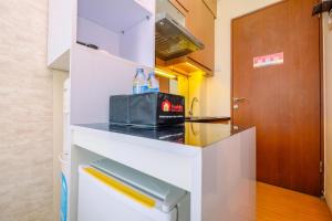 Minimalist Studio with Great City View at Tifolia Apartment By Travelio