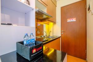 Minimalist Studio with Great City View at Tifolia Apartment By Travelio