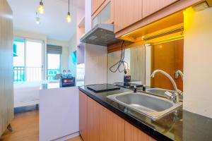 Minimalist Studio with Great City View at Tifolia Apartment By Travelio