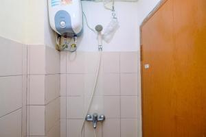 Minimalist Studio with Great City View at Tifolia Apartment By Travelio