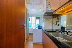 Minimalist Studio with Great City View at Tifolia Apartment By Travelio