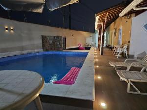 Casa Lindíssima e Espaçosa com 2 Piscinas - Adulto e Infantil, Perto da Praia, Opção da Piscina Adulto Aquecida Cobrado à Parte, 4 Quartos Frente as Piscinas, Área Gourmet Completa com Churrasqueira, Forno e Fogão a Lenha, Mesa de Bilhar, Lare