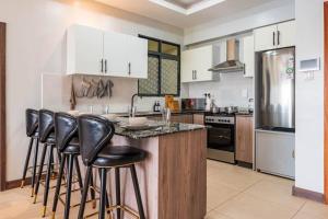 Lush Retreat Near Yaya Center with Pool, Gym & Views