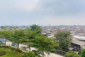 Restful and Modern 2BR Bassura City Apartment By Travelio