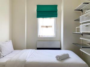 Modern Look and Comfortable 2BR Green Pramuka City Apartment By Travelio