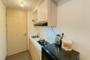 Warm and Homey Studio Tokyo Riverside PIK 2 Apartment By Travelio