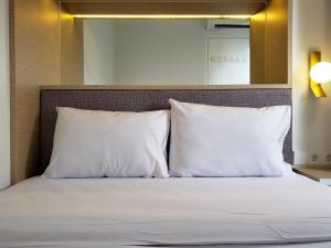 Minimalist and Cozy 2BR at La Hub City Apartment By Travelio