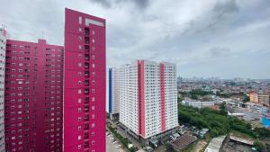 Cozy and Well Designed 2BR at Green Pramuka City Apartment By Travelio