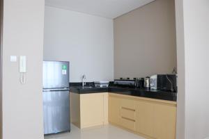 Spacious and Comfy 3BR Ciputra International Apartment By Travelio