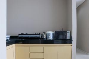 Spacious and Comfy 3BR Ciputra International Apartment By Travelio