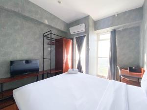 Homey and Good Choice Studio at Amartha View Apartment By Travelio