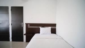 Simple 2BR with Extra Bed at Menara Rungkut Apartment By Travelio