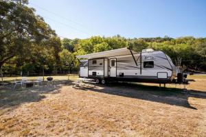 RV located on private property, providing access to the Guadalupe River, accommodates up to 7 guests