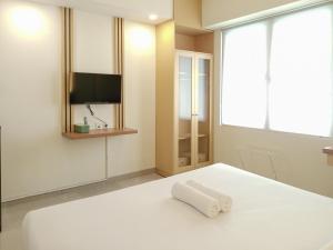 Cozy Stay Studio Room at Altuz Seturan Yogyakarta Apartment By Travelio
