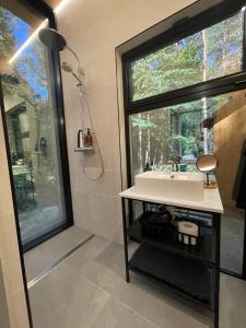 Telise TinyOne is a modern forest cabin with a cozy hot tub