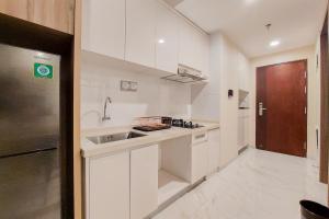 Spacious and Homey 2BR at Sky House BSD Apartment By Travelio