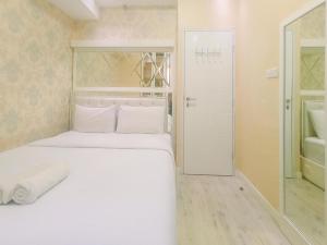 Modern 2BR Green Pramuka City Apartment near Shopping Center By Travelio