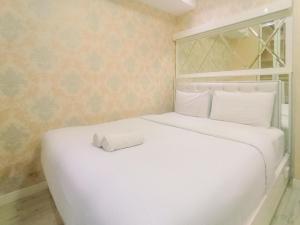 Modern 2BR Green Pramuka City Apartment near Shopping Center By Travelio