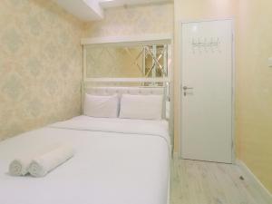 Modern 2BR Green Pramuka City Apartment near Shopping Center By Travelio