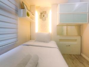 Modern 2BR Green Pramuka City Apartment near Shopping Center By Travelio